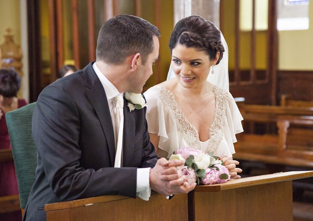 bride and groom chatting in church
