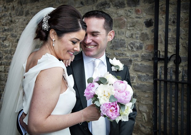 bride with light pink and white wedding bouquet