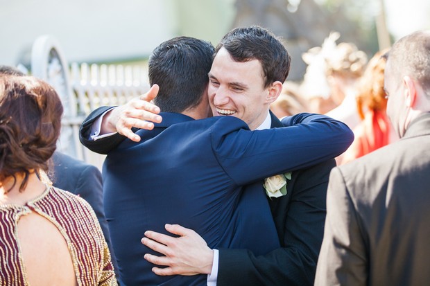 groomsmen hugging outside church