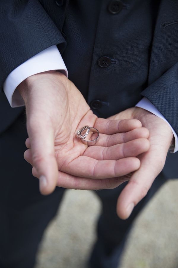best man holding wedding rings
