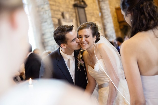 bride and groom kiss on cheek