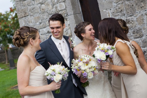 groom and bridesmaids laughing