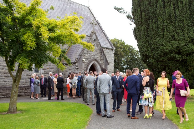 8-wedding-guests-gathering-outside-church