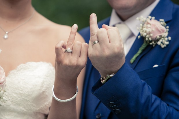 bride-and-groom-showing-off-wedding-rings-clontarf-castle-real-wedding