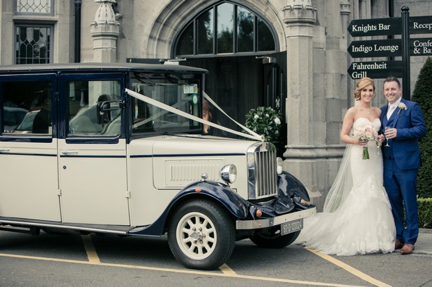 bride-and-groom-with-vintage-car-outsode-clontarf-castle