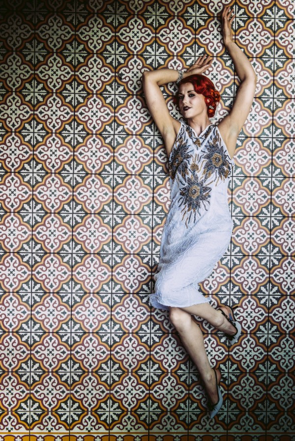 Model lying on ground, vintage flapper dress, red hair, 20s.